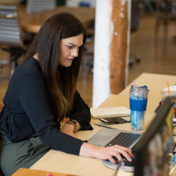 woman working at desk in coworking space