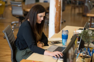 woman working at desk in coworking space