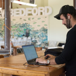 man working at a standing desk at Groundwork