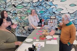 Groundwork members gather to eat cookies in the kitchen