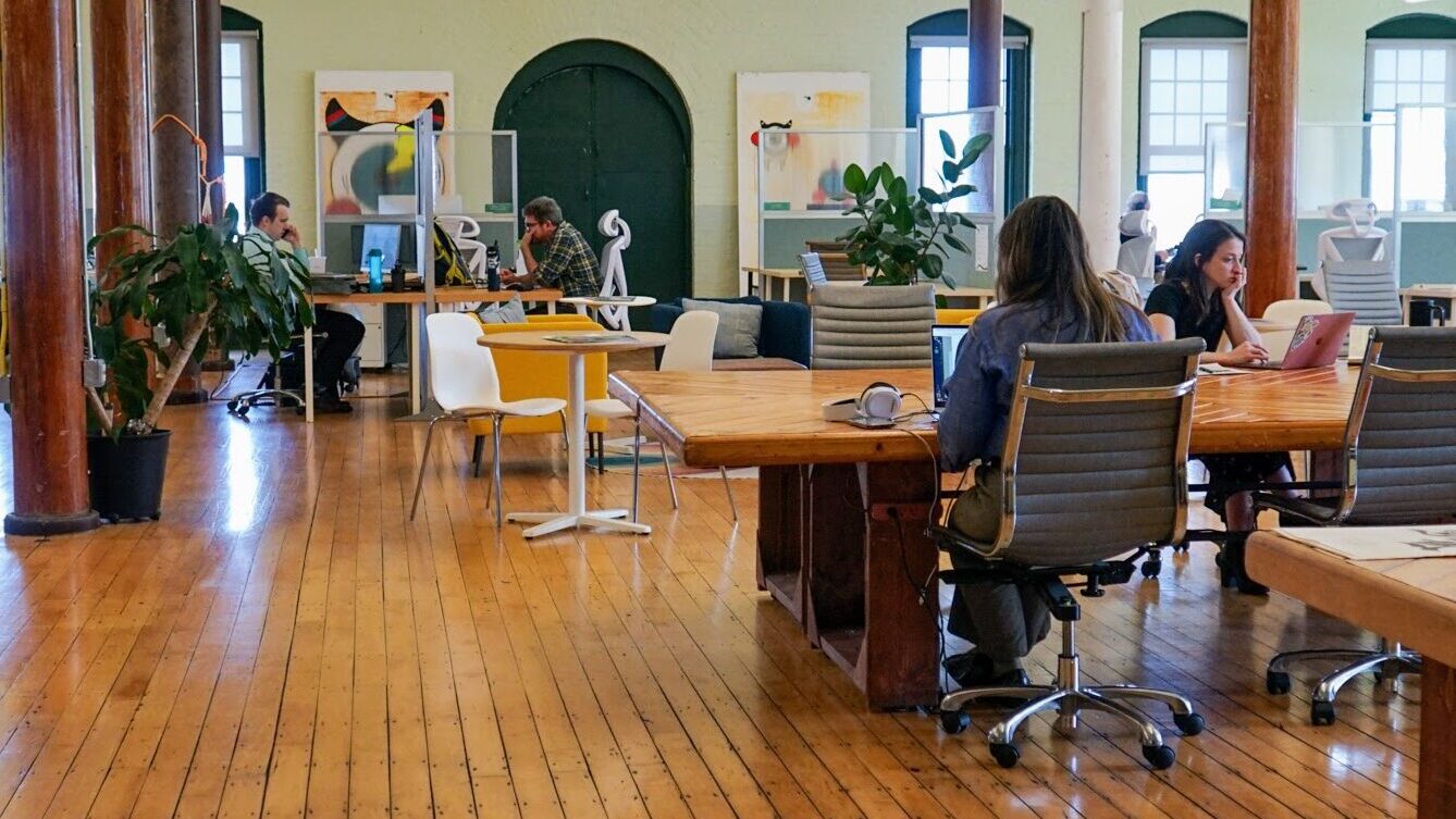 coworking spaces combat loneliness. set of remote workers working in a coworking space 